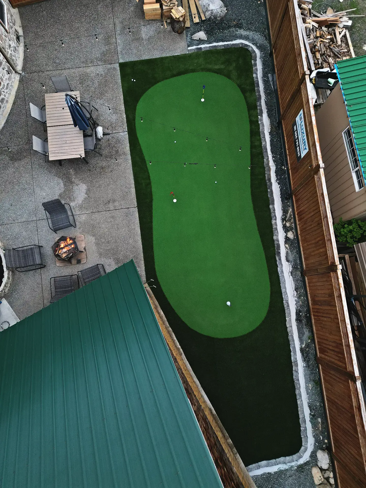 Chilliwack Airbnb property with putting green and landscape lighting at dusk